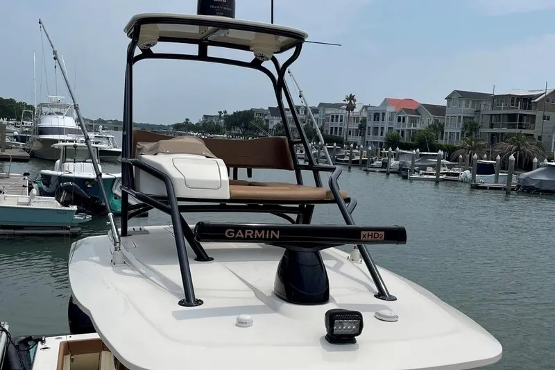 Slide: The Image of 2020 Scout 420 LXF boat with Garmin radar, docked in a marina. - 15