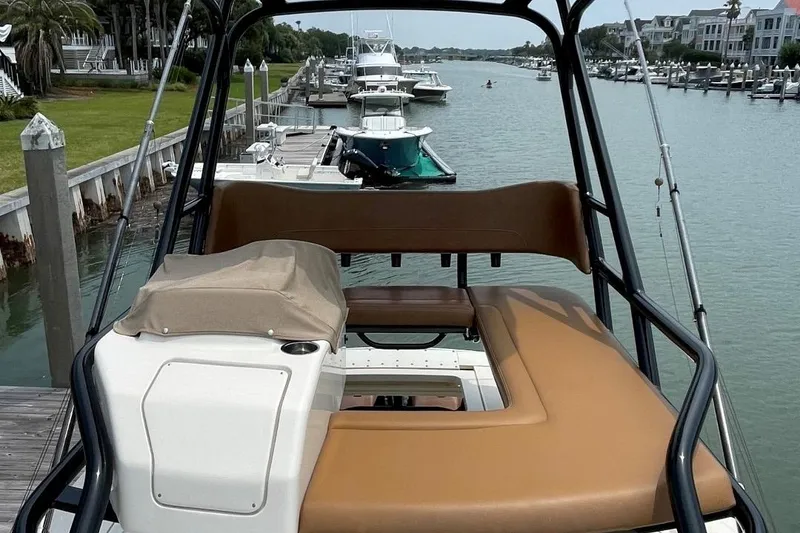 Slide: The Image of 2020 Scout 420 LXF boat docked in a scenic marina. - 18