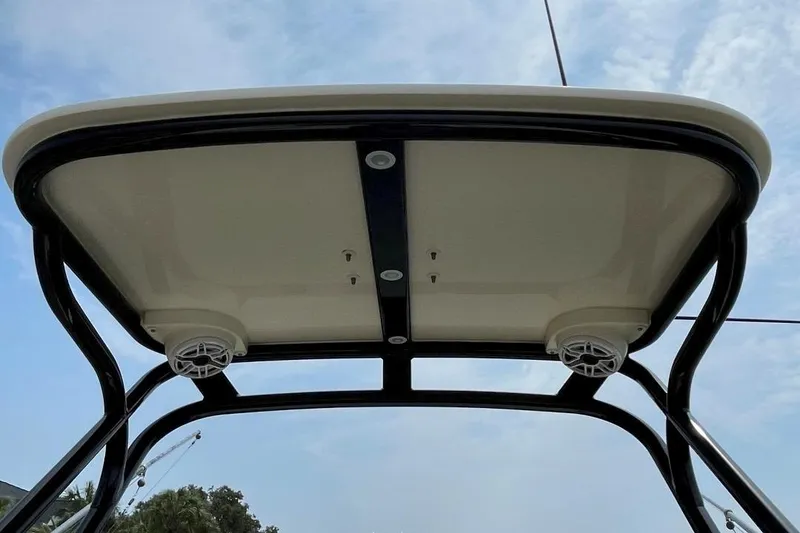Slide: The Image of T-top view of 2020 Scout 420 LXF boat with speakers and sky background. - 21