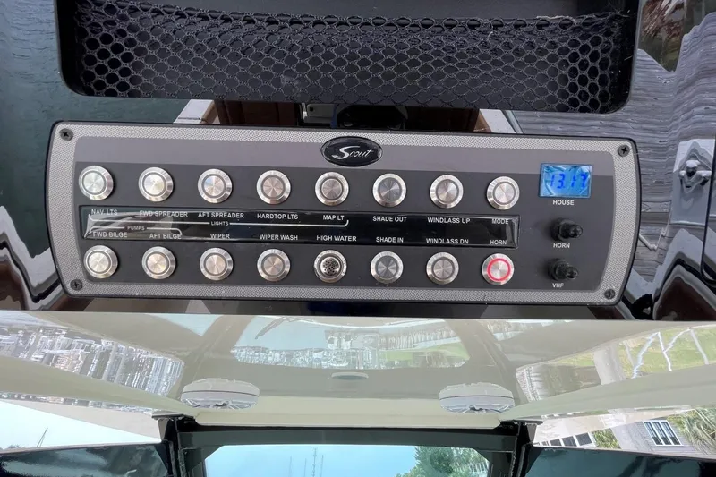 Slide: The Image of Control panel of a 2020 Scout 420 LXF boat with various switches and digital display. - 28