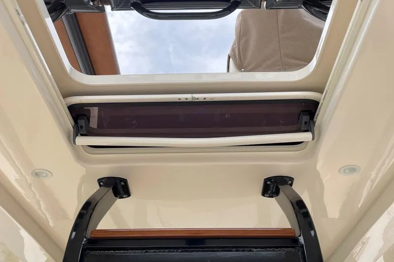 Slide: The Image of 2020 Scout 420 LXF boat interior roof hatch with open sky view. - 38