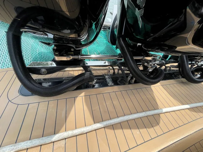 Slide: The Image of 2020 Scout 420 LXF boat deck with engine components and teak flooring. - 44