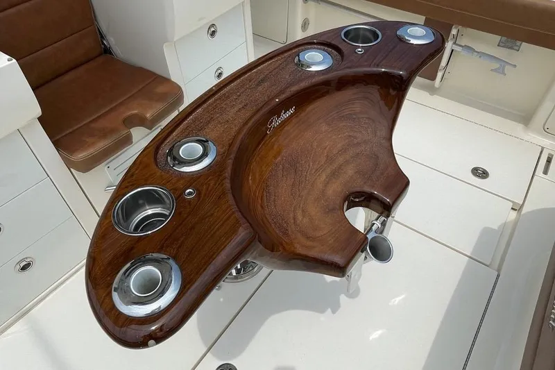 Slide: The Image of Luxurious wooden helm station on 2020 Scout 420 LXF boat with cup holders. - 47