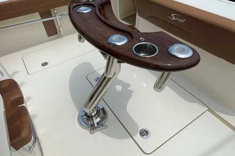 Slide: The Image of 2020 Scout 420 LXF boat interior with polished rod holders and seating. - 48