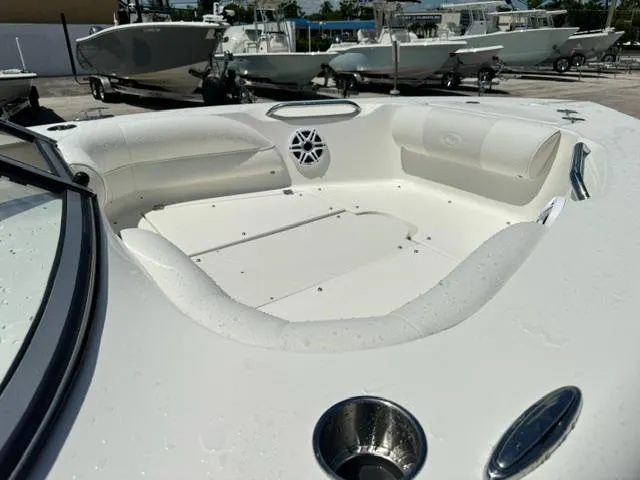 Slide: The Image of 2026 Key West 203 DFS boat interior with seating and speaker, docked with other boats. - 8