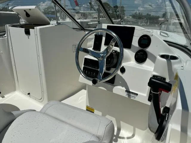 Slide: The Image of 2026 Key West 203 DFS boat cockpit with steering wheel and dashboard controls. - 9