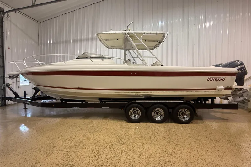 Slide: The Image of 2000 Intrepid 322 boat on trailer in indoor storage facility. - 27