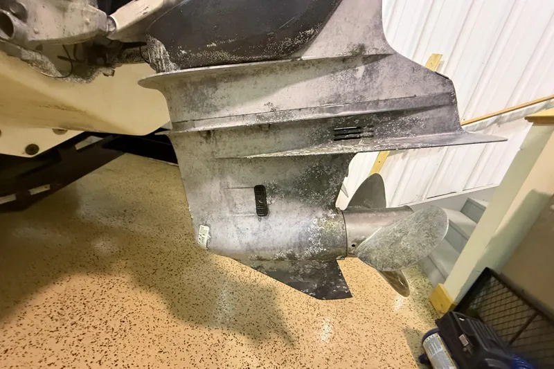 Slide: The Image of Close-up of a 2000 Intrepid 322 boat propeller and lower unit in a garage. - 29