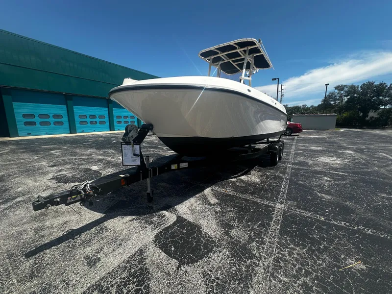 Slide: The Image of 2022 Bayliner Trophy T22CC boat dashboard with steering wheel and navigation controls. - 4