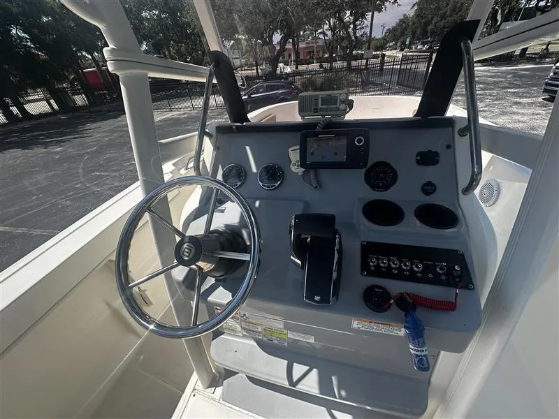 Slide: The Image of 2022 Bayliner Trophy T22CC boat interior with seating and steering console. - 5