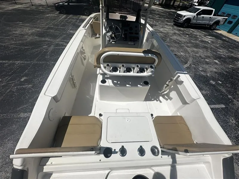 Slide: The Image of 2022 Bayliner Trophy T22CC boat with tan seating, parked in a lot. - 6