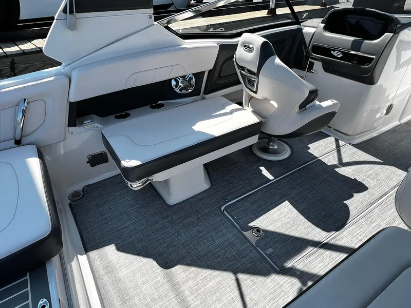 Slide: The Image of 2018 Chaparral 257 SSX boat interior with seating and helm, featuring modern design and upholstery. - 10
