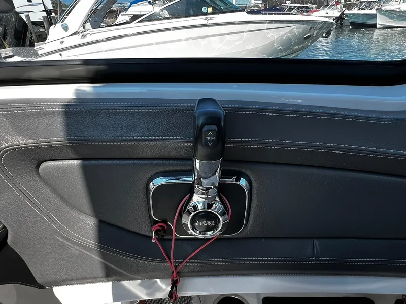 Slide: The Image of Interior view of 2018 Chaparral 257 SSX boat throttle control, with sleek design and stitching. - 14
