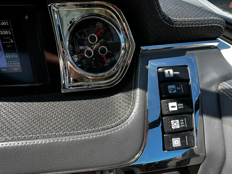 Slide: The Image of Dashboard controls of a 2018 Chaparral 257 SSX boat with gauges and switches. - 17