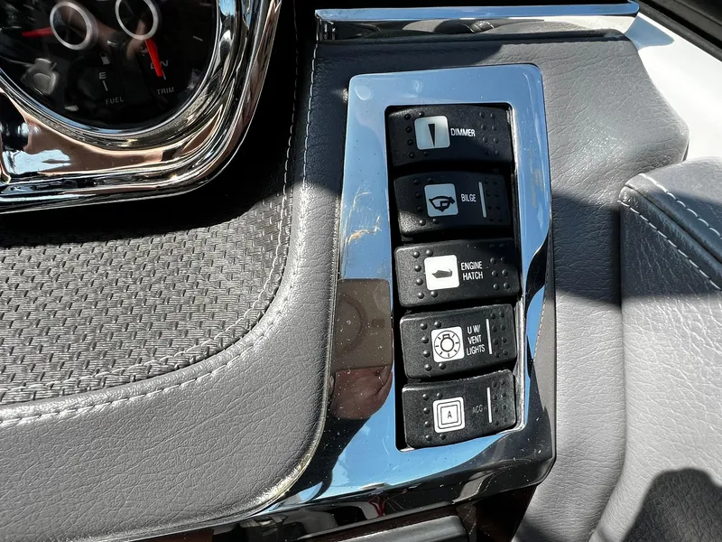 Slide: The Image of Control panel of a 2018 Chaparral 257 SSX boat with various switches and gauges. - 18