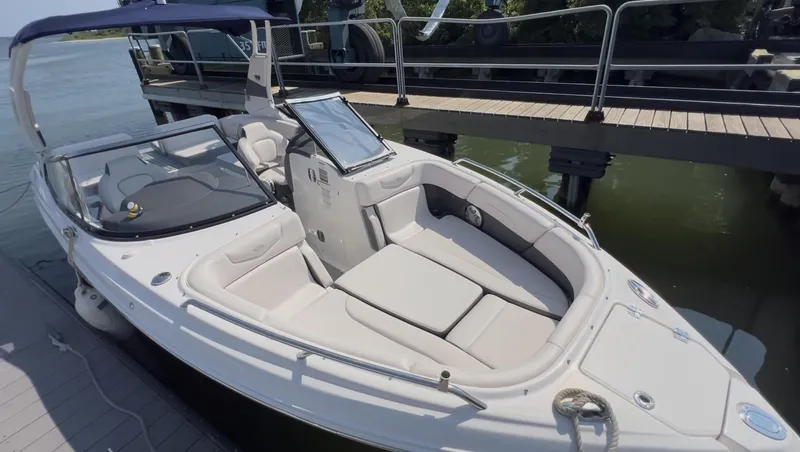 Slide: The Image of 2018 Chaparral 257 SSX boat docked, featuring spacious seating and sleek design. - 2