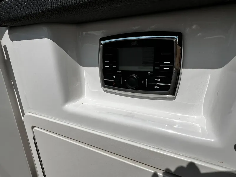 Slide: The Image of Control panel on 2018 Chaparral 257 SSX boat, featuring a Polk audio system. - 23