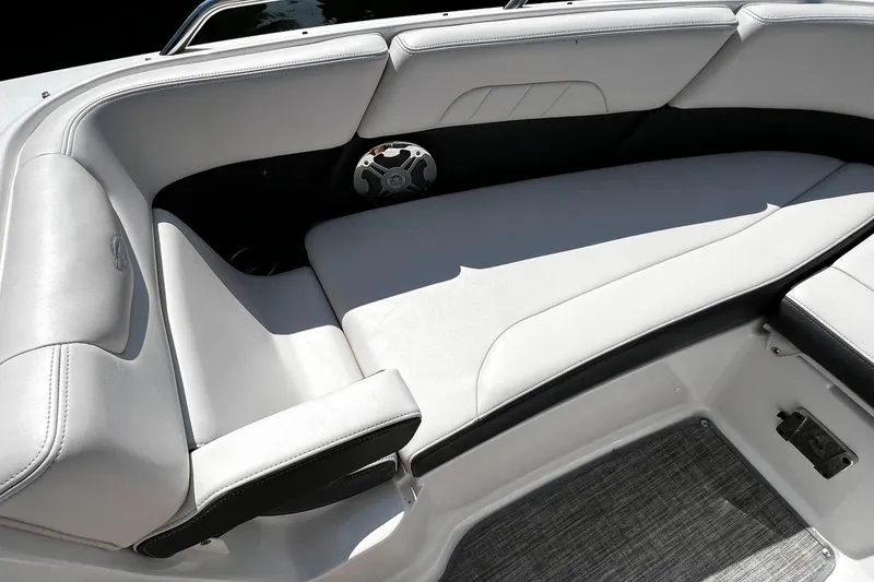 Slide: The Image of 2018 Chaparral 257 SSX boat interior with white cushioned seating and speaker. - 26