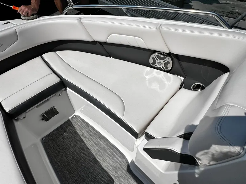 Slide: The Image of 2018 Chaparral 257 SSX boat interior with white seating and speaker detail. - 28