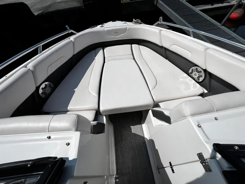 Slide: The Image of 2018 Chaparral 257 SSX boat interior with white cushioned seating and speakers. - 30