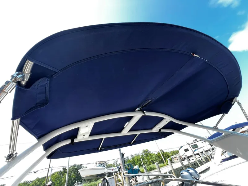 Slide: The Image of 2018 Chaparral 257 SSX boat with blue bimini top under clear sky. - 31