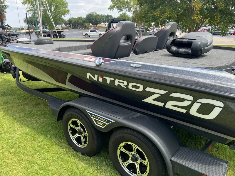 Slide: The Image of 2023 Nitro Z20 boat on trailer with dual wheels, parked on grass. - 12