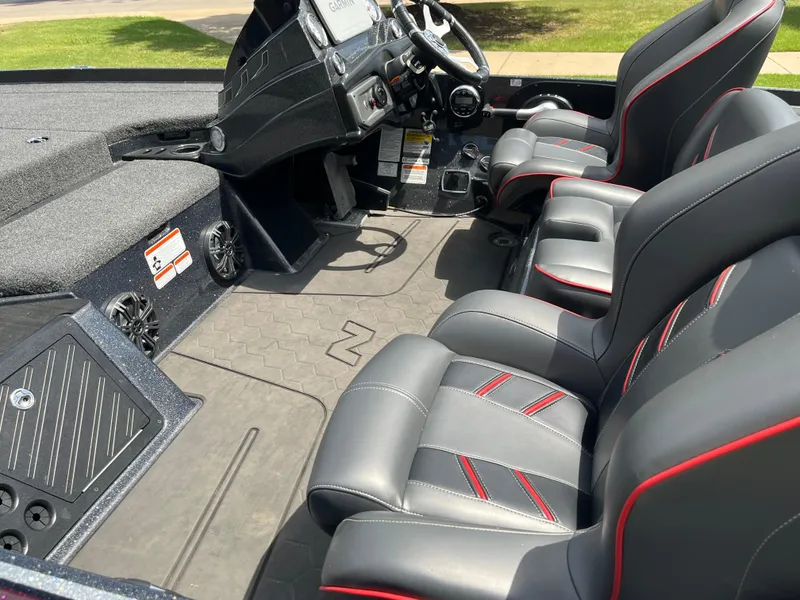 Slide: The Image of 2023 Nitro Z20 boat interior with sleek gray and red-trimmed seats. - 14