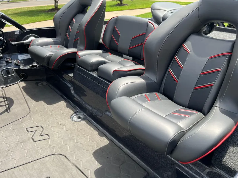 Slide: The Image of 2023 Nitro Z20 boat on trailer, parked outside a building under clear blue sky. - 15