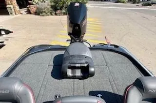 Slide: The Image of 2023 Nitro Z20 boat with motor, parked on a sunny street. - 19