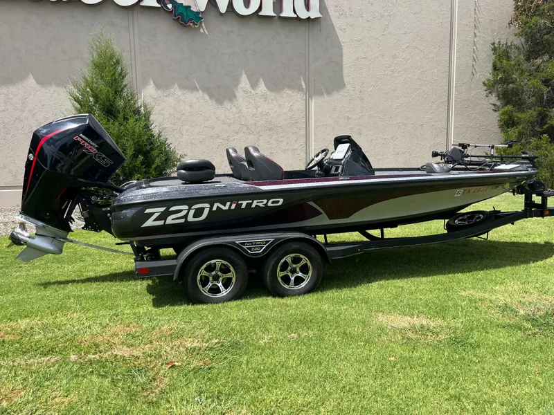 Slide: The Image of 2023 Nitro Z20 boat with powerful engine, sleek design, and comfortable seating on grass. - 2