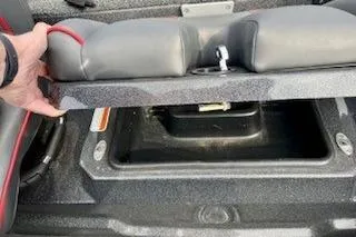 Slide: The Image of 2023 Nitro Z20 boat storage compartment with cushioned seat lifted. - 22