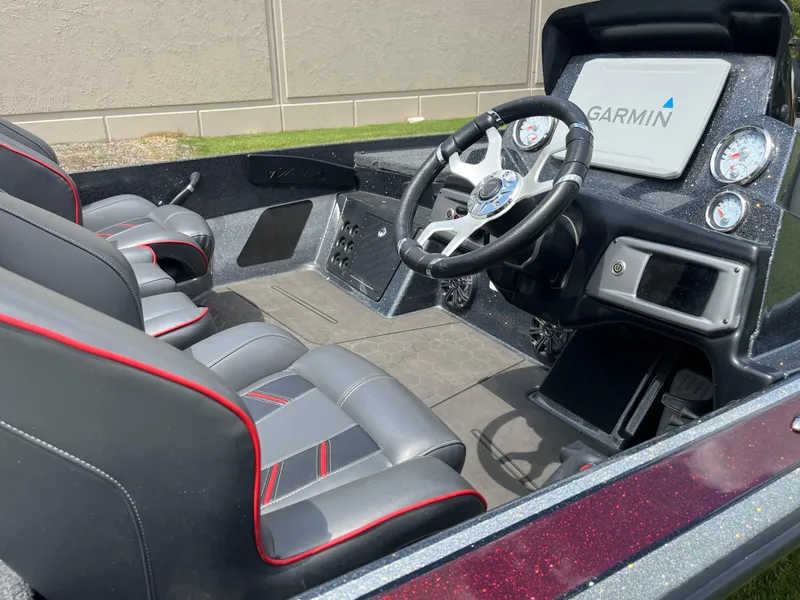 Slide: The Image of Interior of a 2023 Nitro Z20 boat featuring steering wheel and dashboard controls. - 8