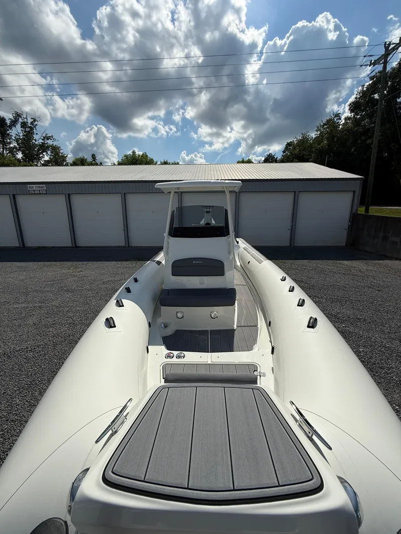 Slide: The Image of 2026 Brig Eagle 8 boat parked outdoors under a cloudy sky. - 16