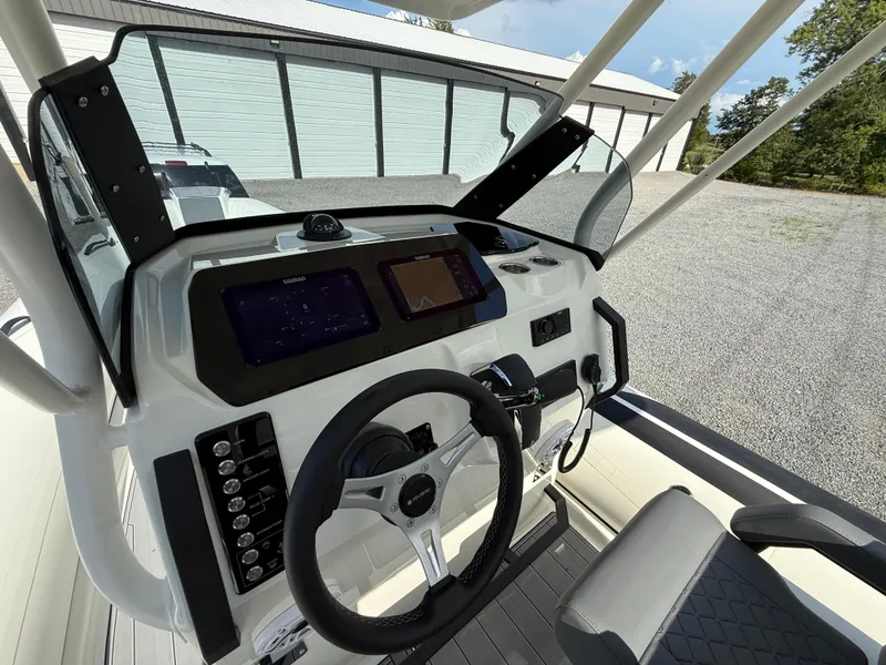 Slide: The Image of 2026 Brig Eagle 8 boat dashboard with steering wheel and navigation screens. - 18