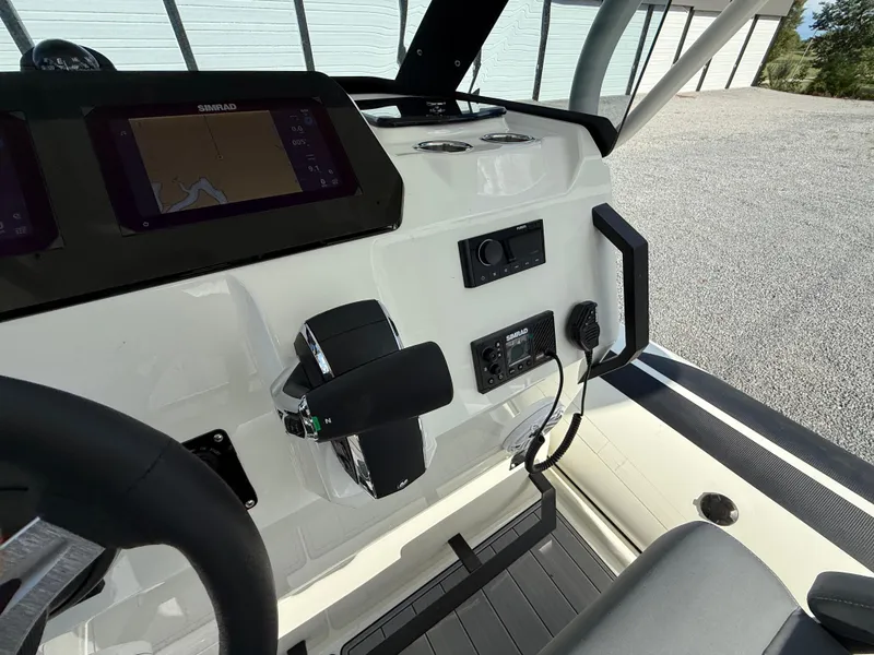 Slide: The Image of 2026 Brig Eagle 8 boat dashboard with navigation controls and Simrad display. - 20