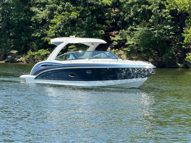 The Image of 2023 Formula 350 Crossover Bowrider I/O cruising on a serene lake. - 0