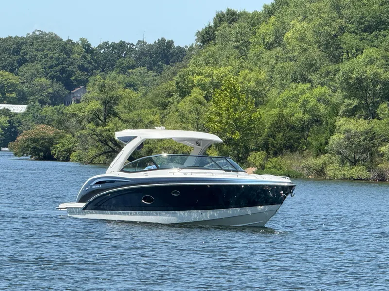 Slide: The Image of 2023 Formula 350 Crossover Bowrider I/O cruising on a scenic lake. - 1