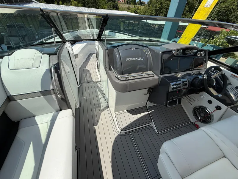 Slide: The Image of 2023 Formula 350 Crossover Bowrider I/O interior with sleek helm and luxurious seating. - 11