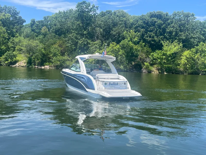Slide: The Image of 2023 Formula 350 Crossover Bowrider I/O on a serene lake with lush greenery. - 30