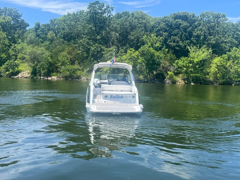 Slide: The Image of 2023 Formula 350 Crossover Bowrider I/O on a serene lake with lush green trees. - 31