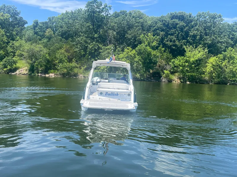 Slide: The Image of 2023 Formula 350 Crossover Bowrider I/O on a serene lake with lush greenery. - 32