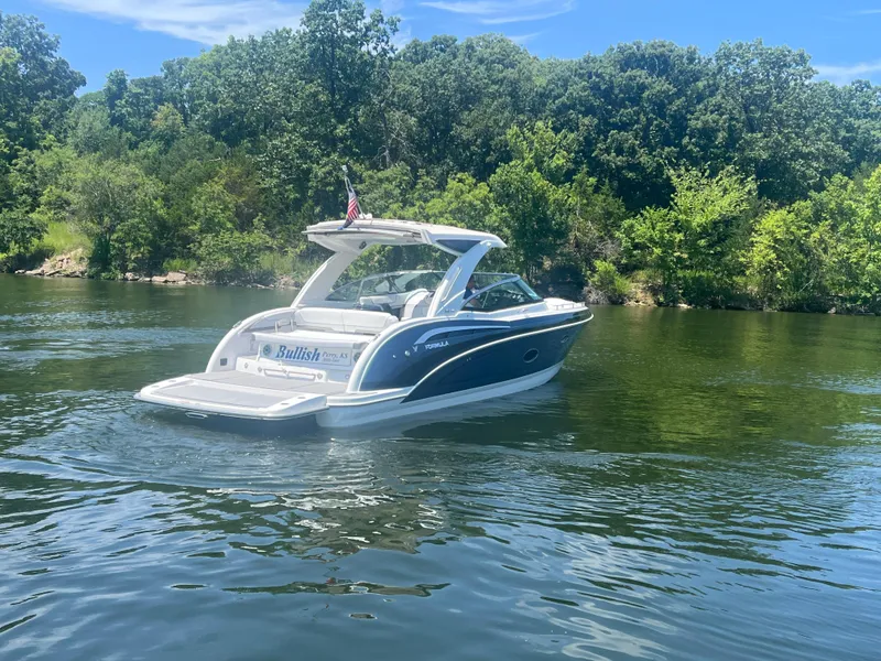 Slide: The Image of 2023 Formula 350 Crossover Bowrider I/O on a scenic lake with lush greenery. - 33