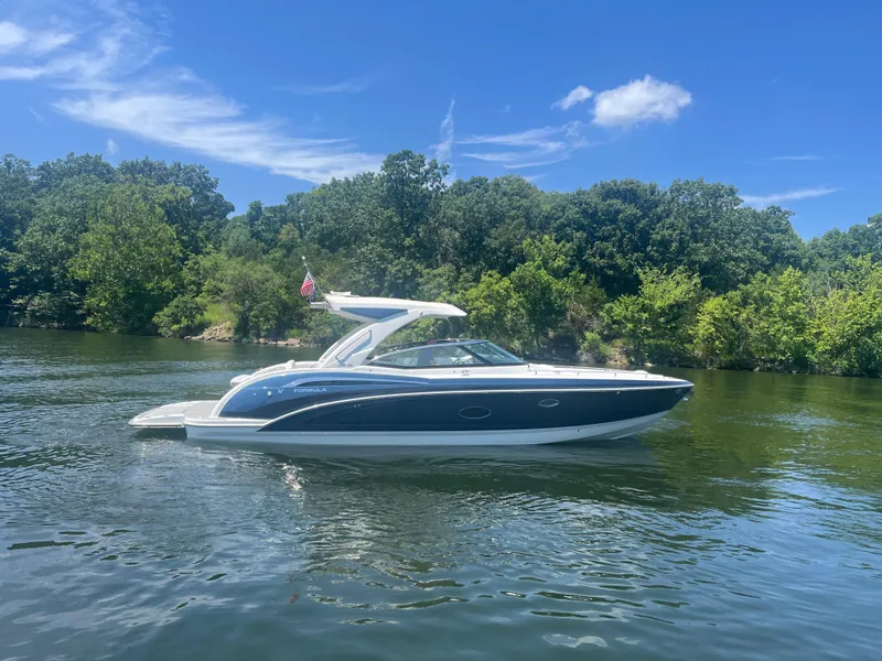 Slide: The Image of 2023 Formula 350 Crossover Bowrider I/O on a serene lake with lush greenery. - 34