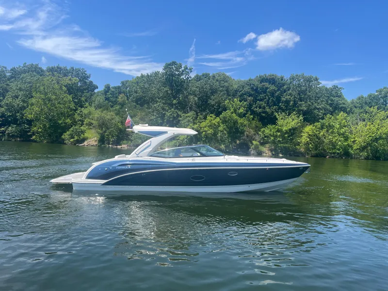 Slide: The Image of 2023 Formula 350 Crossover Bowrider I/O on a serene lake with lush greenery. - 35