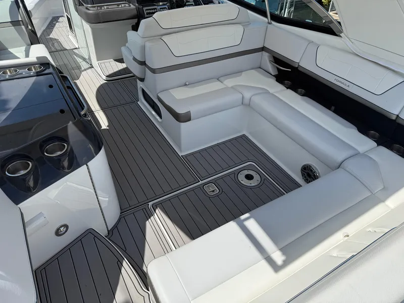 Slide: The Image of 2023 Formula 350 Crossover Bowrider I/O interior with white leather seating and control panel. - 6