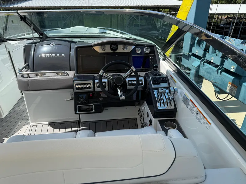 Slide: The Image of 2023 Formula 350 Crossover Bowrider I/O dashboard with steering wheel and controls. - 8