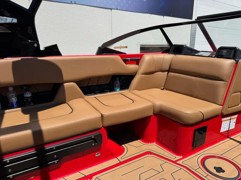 Slide: The Image of 2024 Moomba Craz boat interior with tan seating and red accents. - 10