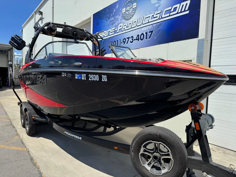Slide: The Image of 2024 Moomba Craz boat in black and red on a trailer outside a marine shop. - 3