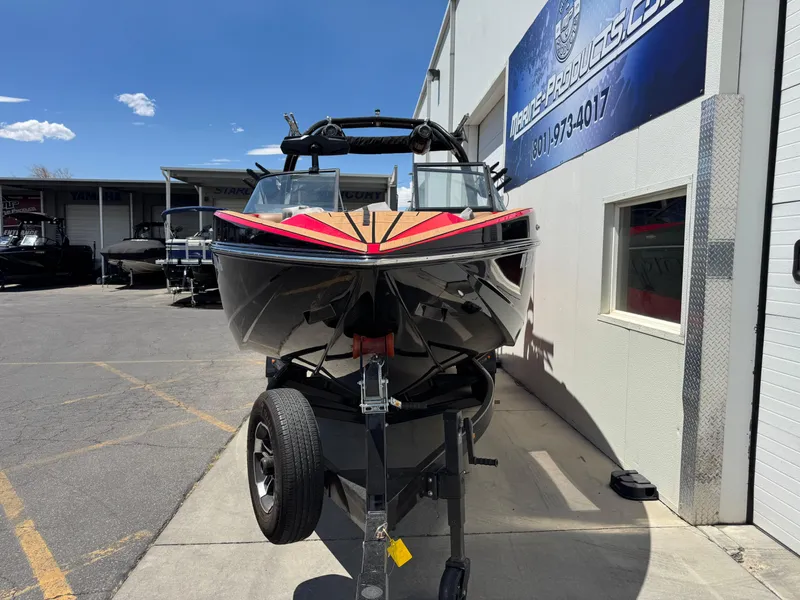 Slide: The Image of 2024 Moomba Craz boat on trailer outside marine dealership. - 4