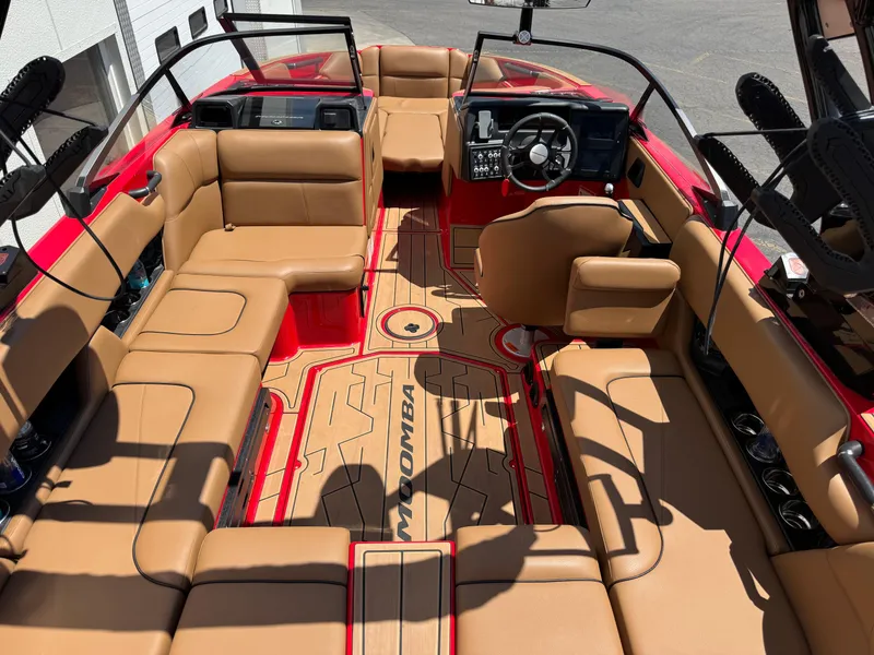 Slide: The Image of 2024 Moomba Craz boat interior with tan seating and red accents. - 6